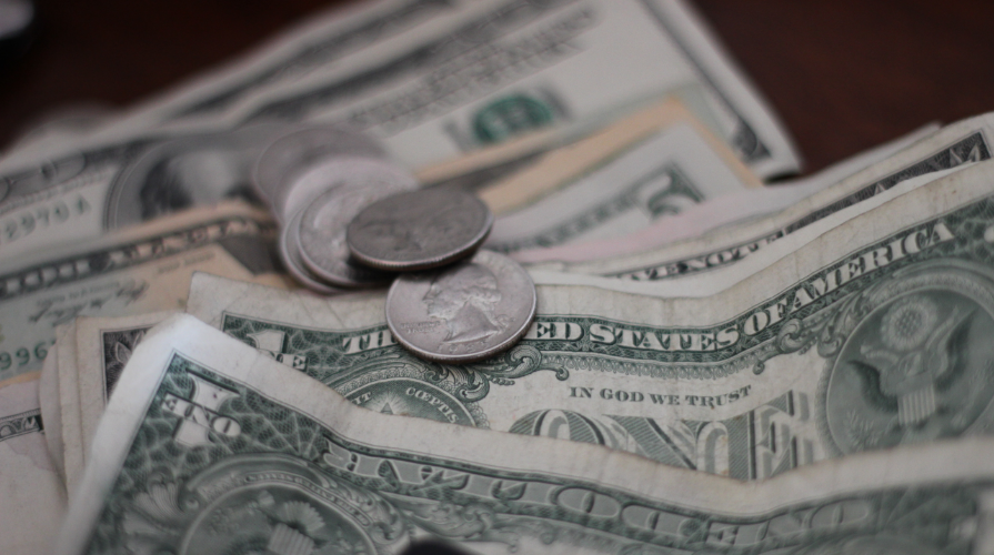 photo of dollar bills and quarters