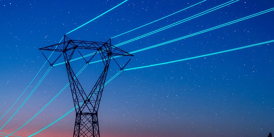 Electricity pilon with glowing cables.