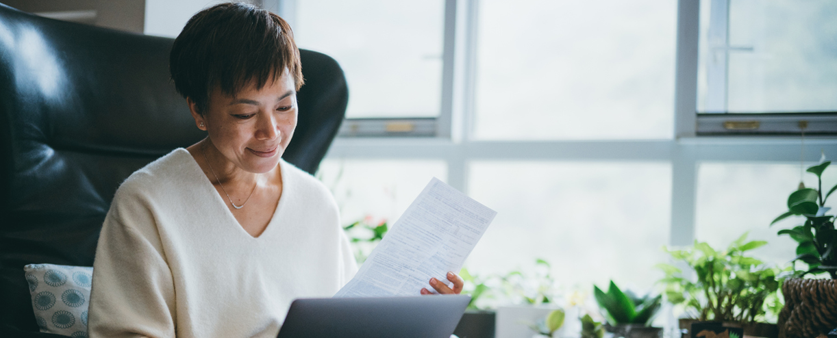 A woman looks at paperwork