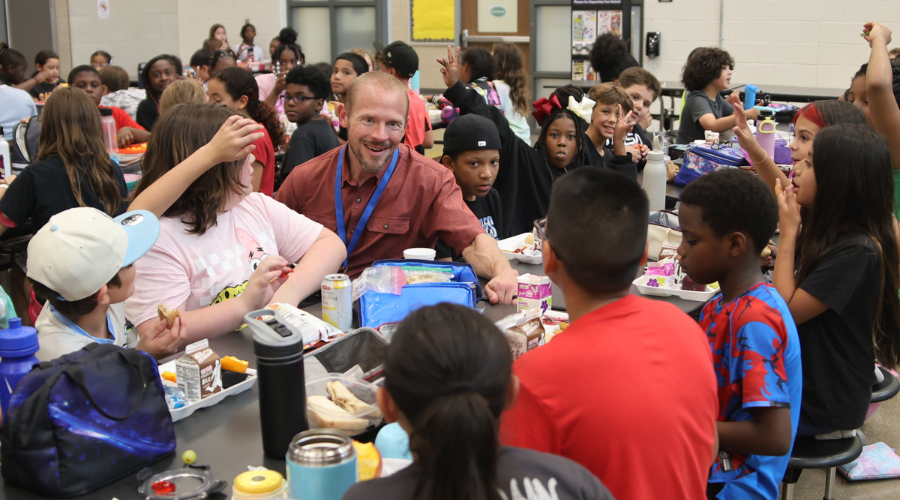 Pflugerville ISD Superintendent Quintin Shepherd chats with students at lunchtime.