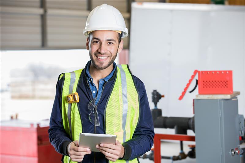 Worker wearing hard hat and yellow safety vest