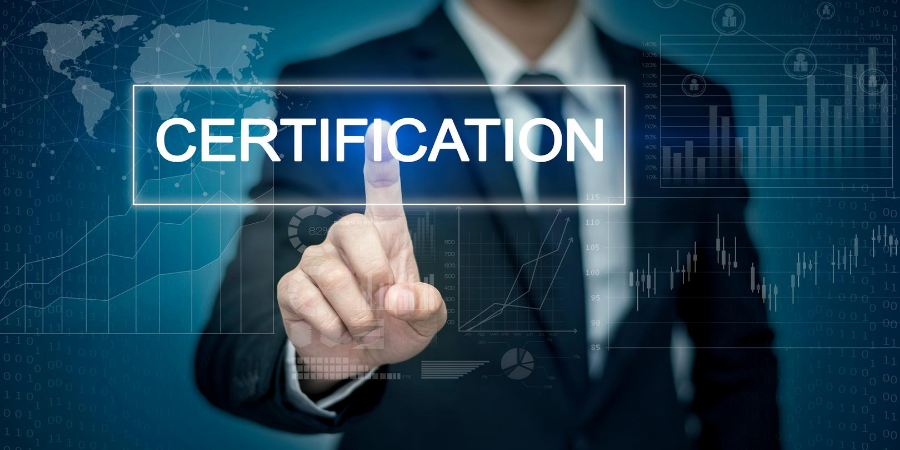 Man's torso standing at an electronic screen touching a button that reads Certification