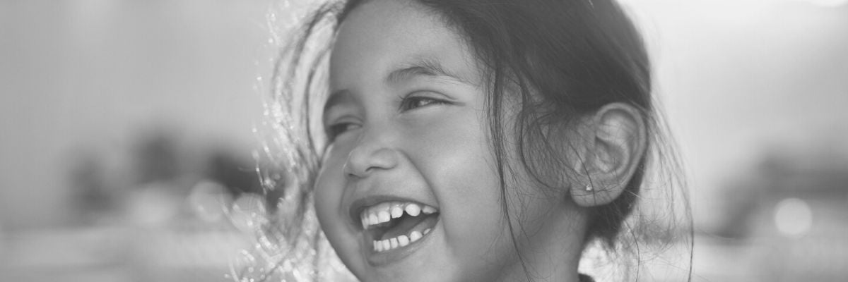 Black and white photo of a young student smiling