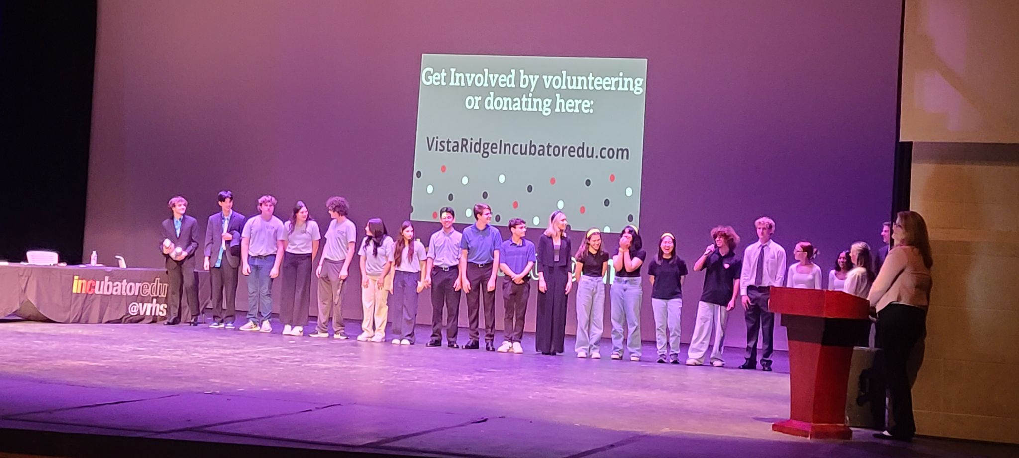 Vista Ridge High School students line up on stage before the judges announce the winner of Pitch Night, the capstone to their INCubator entrepreneurship class. 