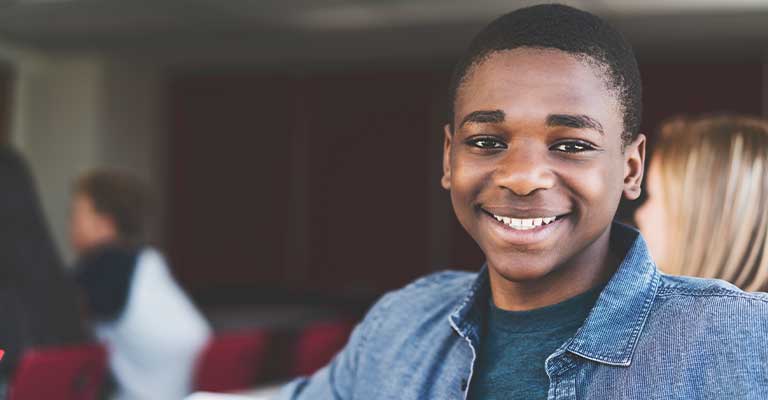 Boy Smiling wearing a jean jacket