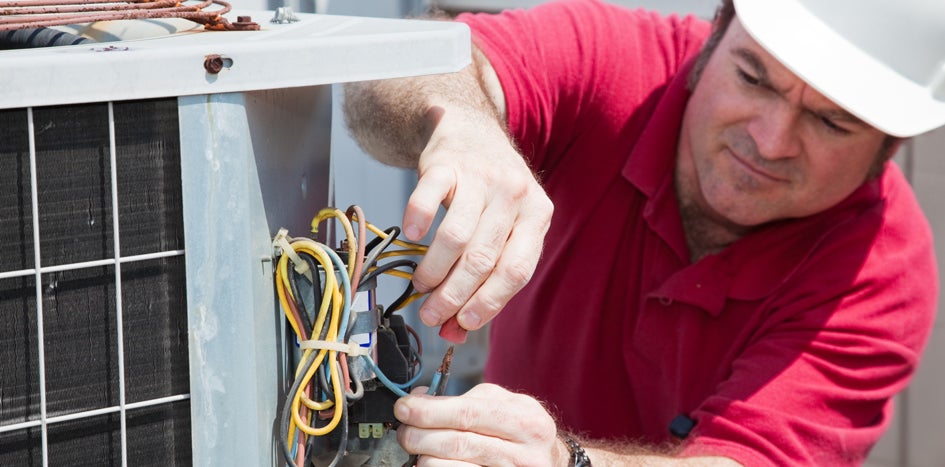 Maintenance technician working on HVAC system