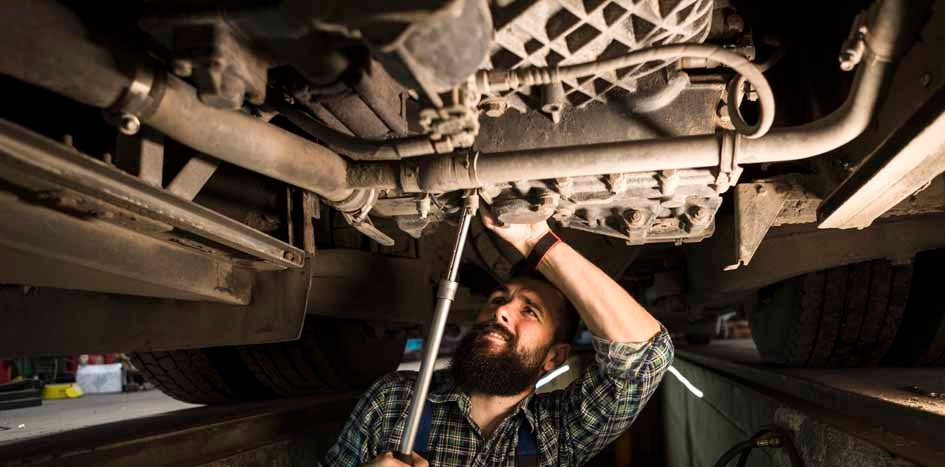 Mechanic working under car