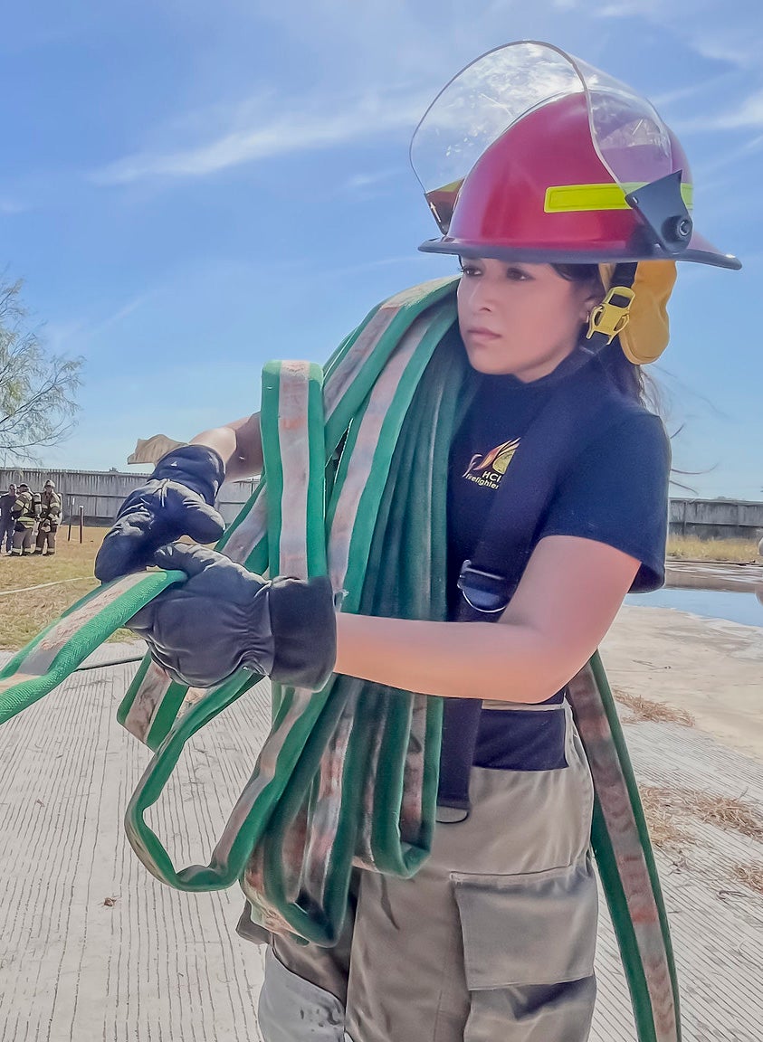 Madison Garciaa, a junior at Harlingen High School, learns how to wrap a water hose as part of her training at the Firefighters Academy. “I think it’s amazing that HCISD has this program,” she said. 