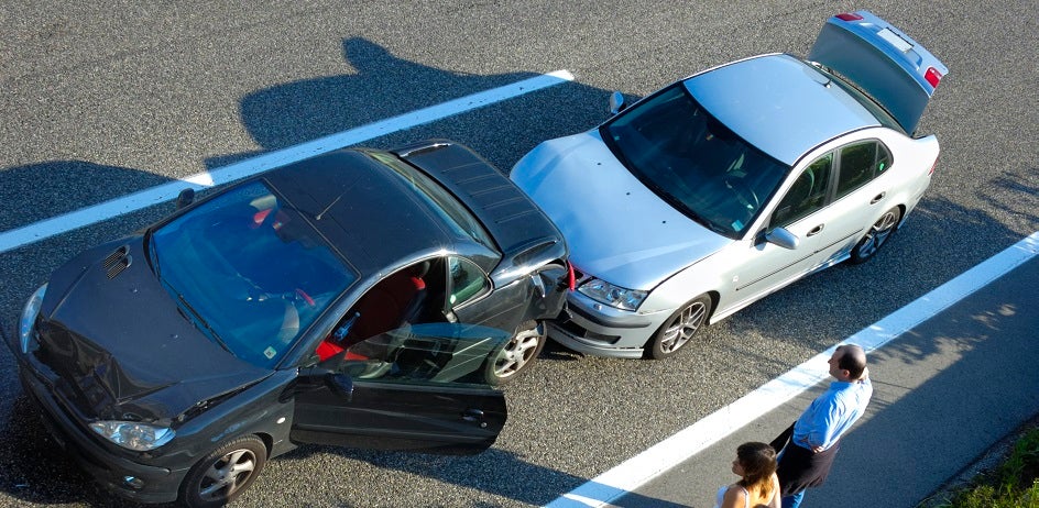 Silver car rear ends black car