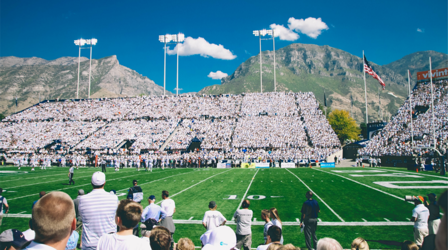 A full football stadium with an active football game happening.