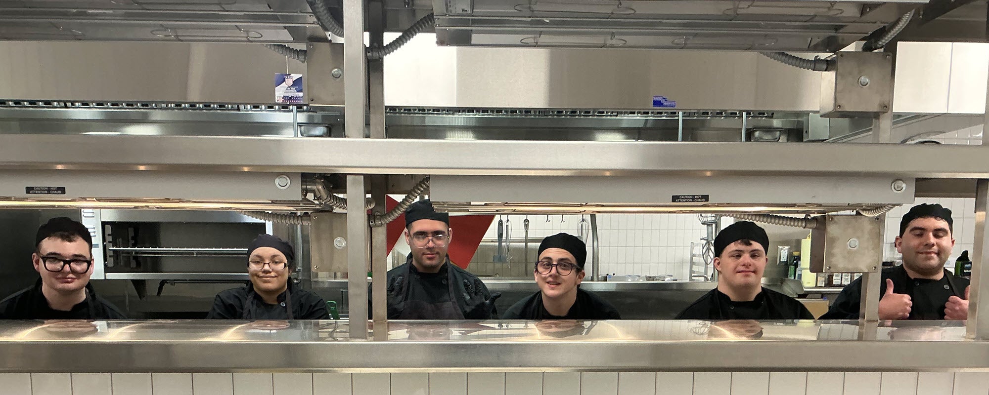 Students work on the line in the Bridges culinary facilities. Georgetown ISD