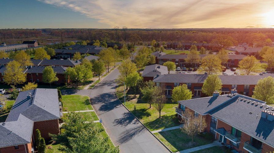photo of neighborhood housing, apartments, sunset or sunrise in the background