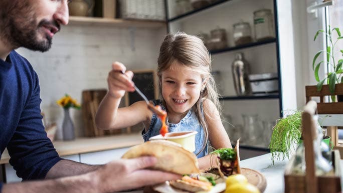 Dad and daughter making healthy tortillas in the kitchen