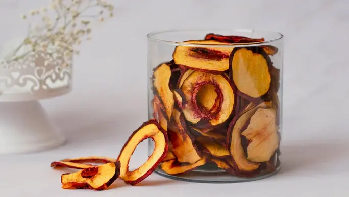 Dried nectarine slices in a glass container