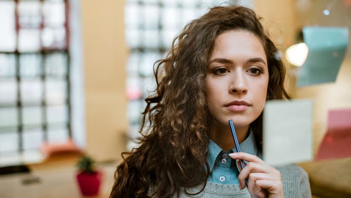 Concentrated woman making plan on sticky notes.