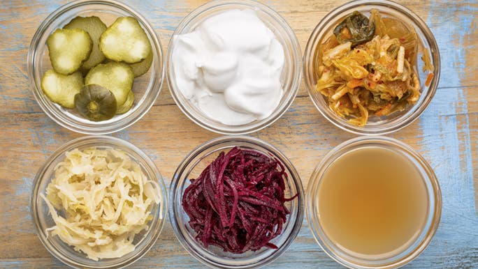 An array of fermented food in small glass bowls, good for gut dysbiosis.
