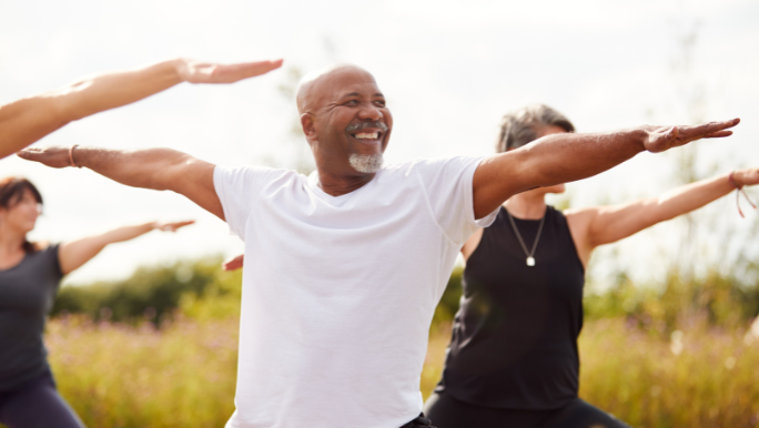 A man is happy to be doing a yoga session outside