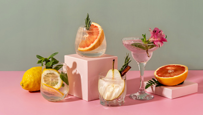 Staged photo of oranges and lemons in alcoholic drinks for alcohol and gut health