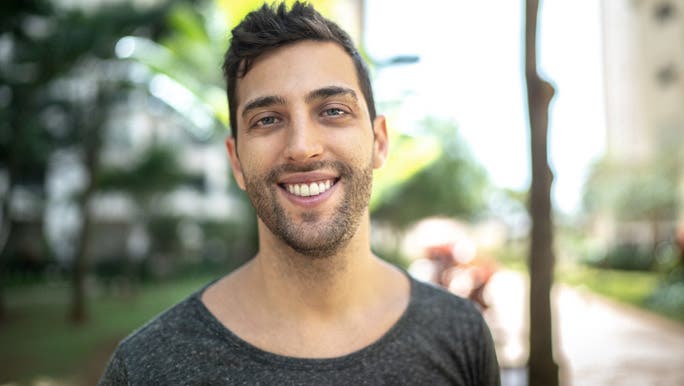 Smiling young man in a grey t-shirt