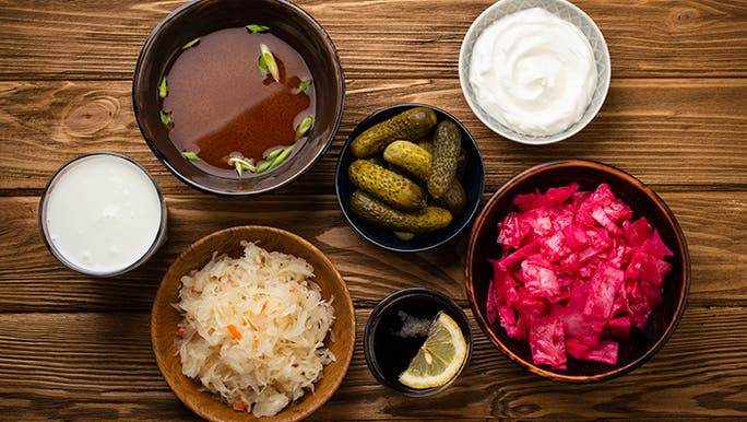 From above, a bunch of bowls containing fermented foods are on a table. They are all rumoured to promote healthy gut flora. 