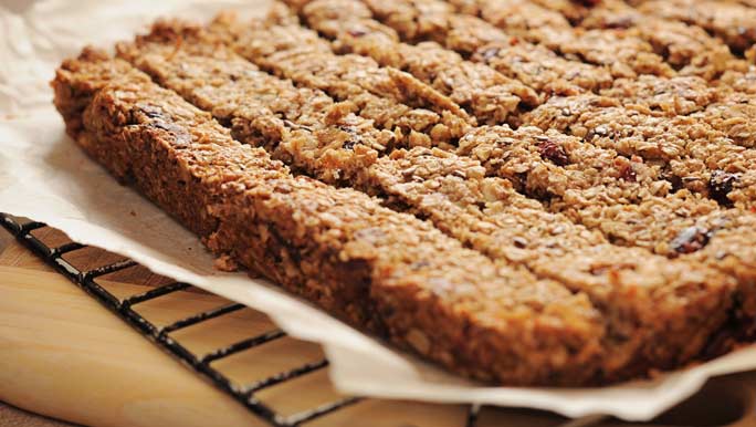 Healthy homemade muesli bars cooling on a wire rack and baking paper