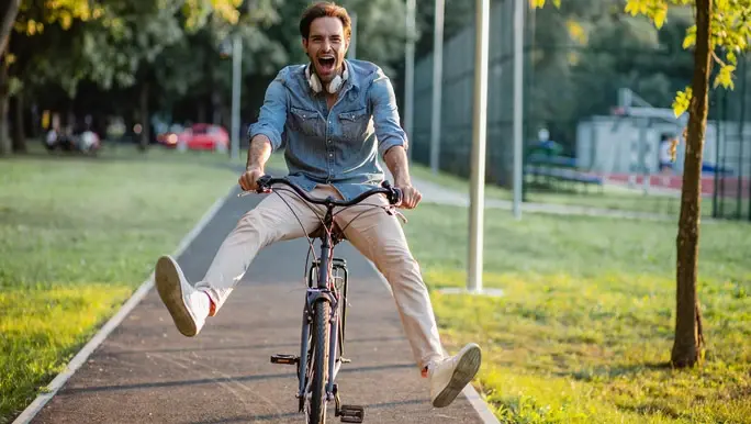Energetic man riding his bike in the park