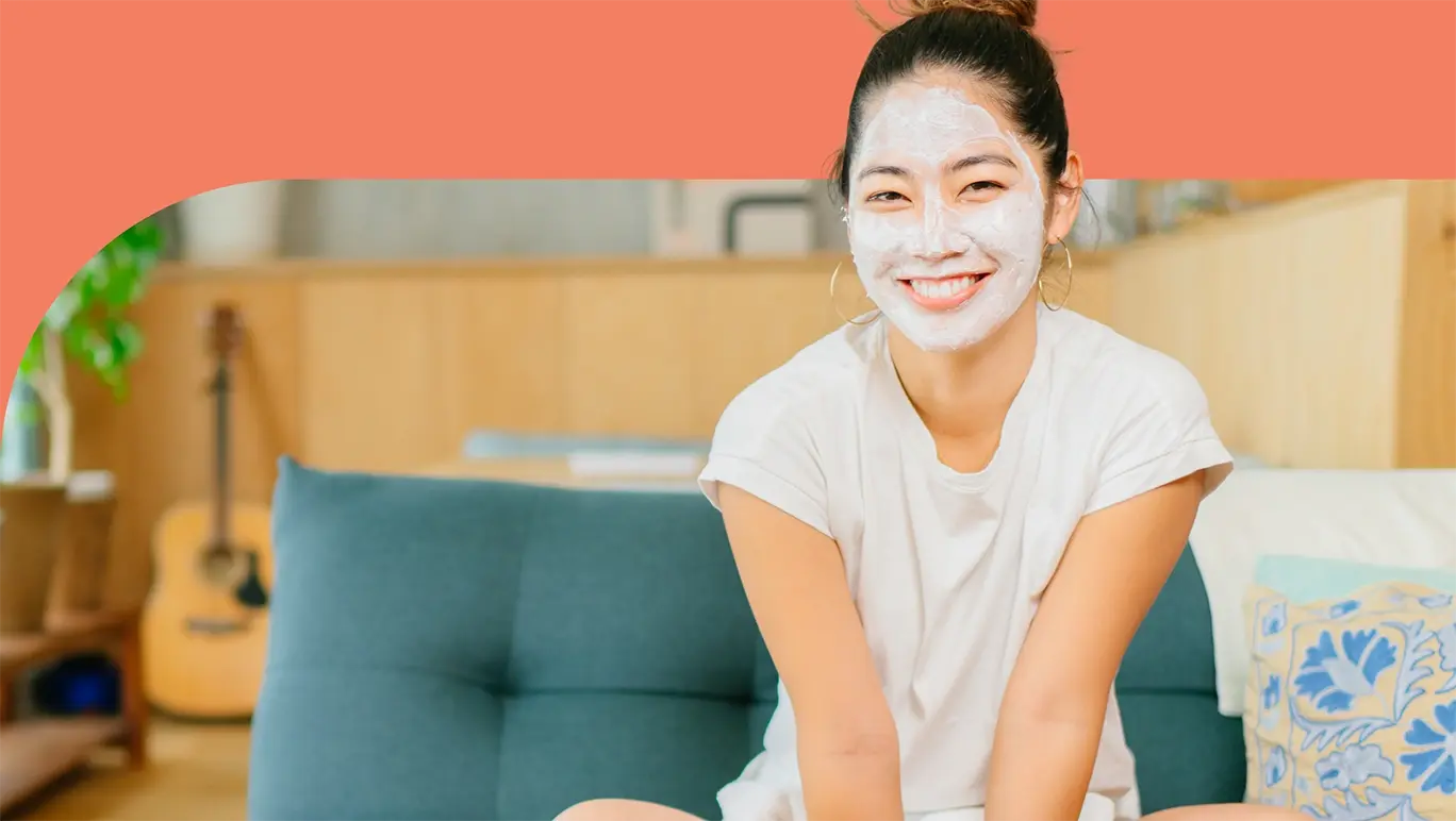 woman sitting on couch wearing face mask