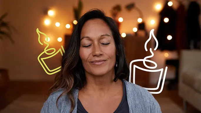 Calm woman meditating in a softly lit room