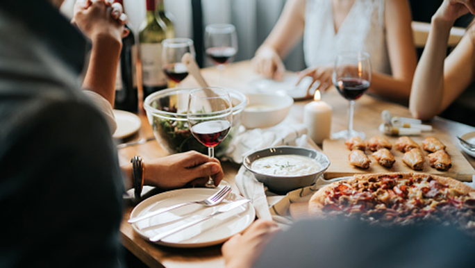 Friends enjoying a meal with alcohol