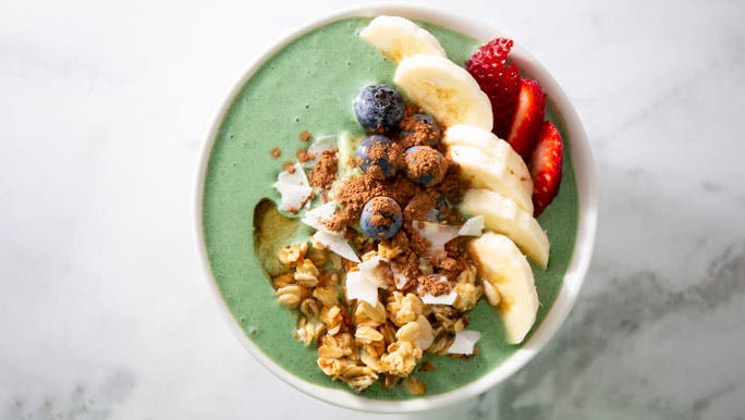 Collagen containing spirulina smoothie bowl with yoghurt and fruit