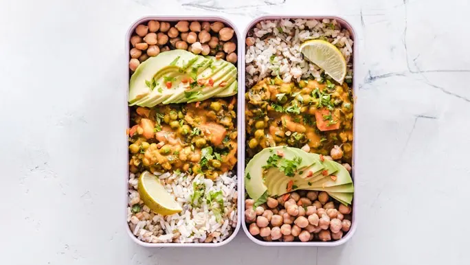 Two lunchboxes side by side with a meal made from non-perishable foods chickpeas and rice