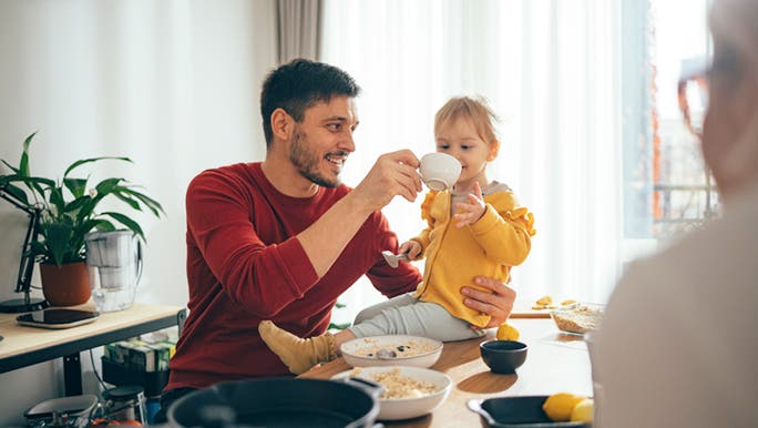 A man and a child are eating oats for breakfast, which are on the low FODMAP food list