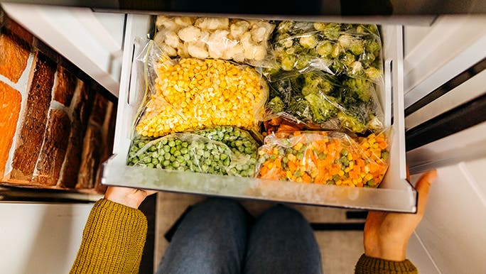 From above, a freezer drawer is filled to the brim with 20+ serves of vegetables. 