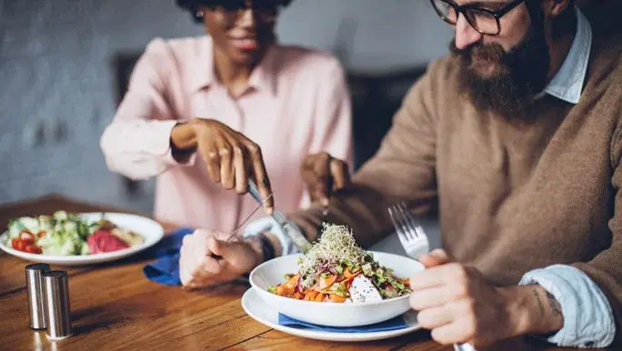 Happy couple having healthy vegetarian dinner