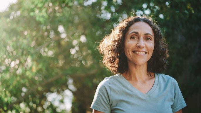 A woman smiles as she enjoys being outdoors