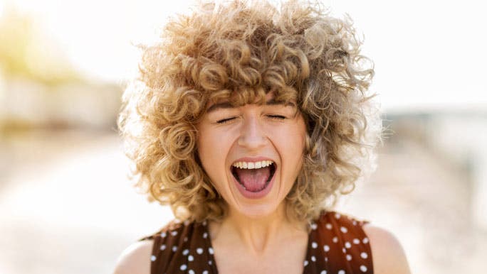 Young woman with curly blonde hair