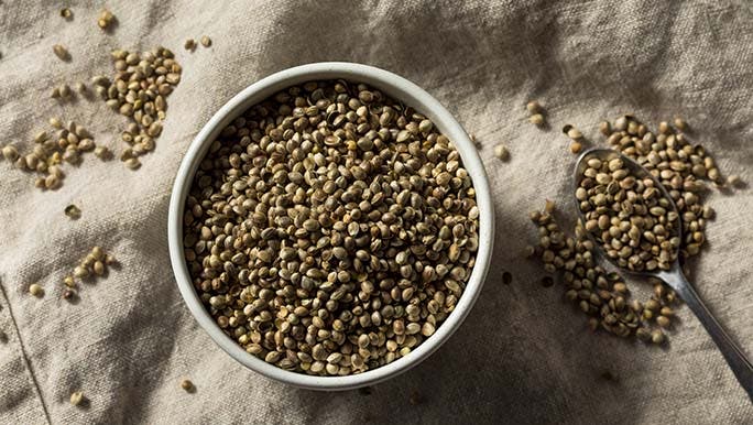 A bowl of hemp seeds viewed from above represents how hemp seed and sleep may be related. 