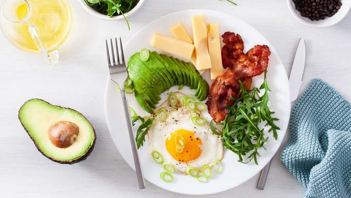 A healthy keto breakfast of avocado, cheese, eggs and bacon