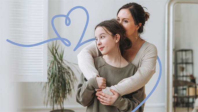 Mother with her arms around her young teenage daughter