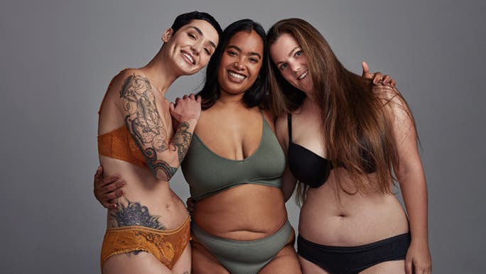 Three very different women post in their underwear, it’s an image typical of the body positive movement. 