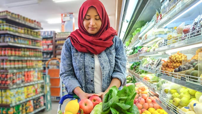 A woman pushes a trolley, it is full of everything you need to do a detox cleanse