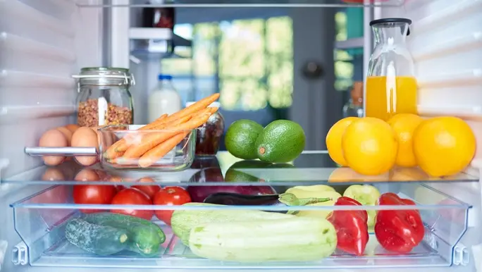 Fresh vegetables and fruits, eggs, juice and cereal in the fridge