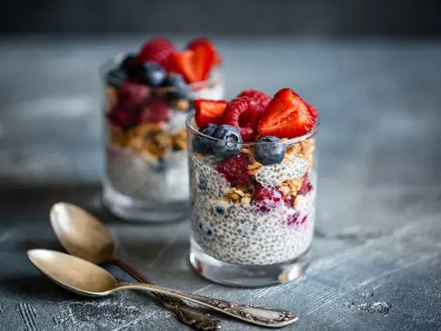 Low FODMAP strawberry and chia pudding with berries and nuts