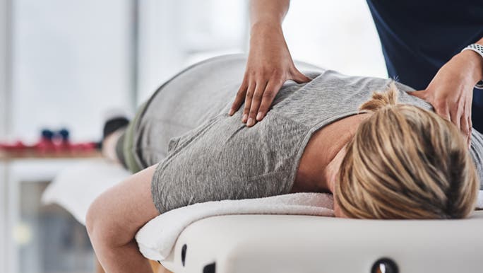 A lady is having a massage after having good food to help her mood.