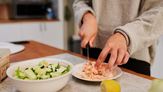 Someone prepares a healthy flexitarian meal on a kitchen island bench.