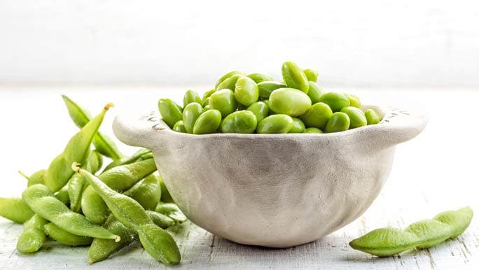 White bowl full of edamame beans