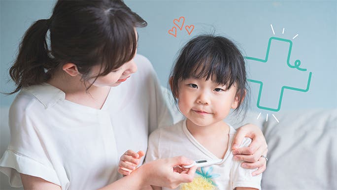 A young mother is checking her daughter's temperature with an underarm thermometer