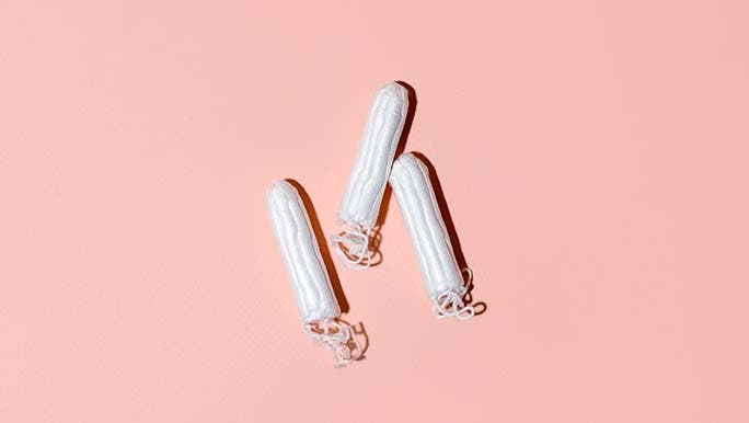 Organic tampons with a pale pink background. 