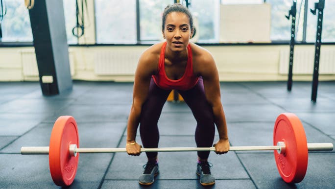 Woman in the gym doing deadlifts