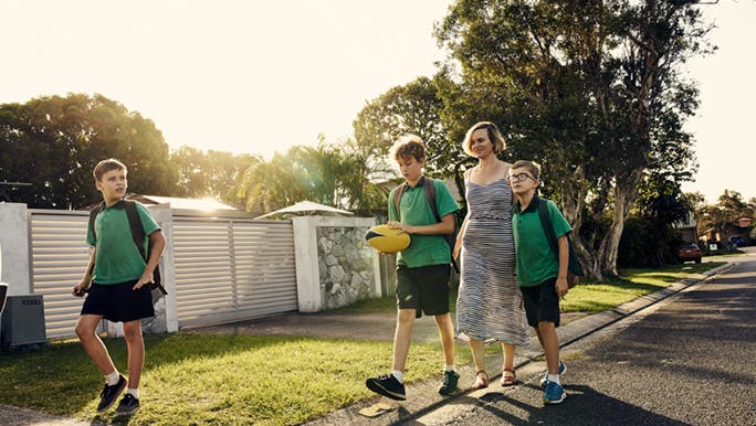A family is walking home from school together and talking about how long it takes to walk 10,000 steps. 